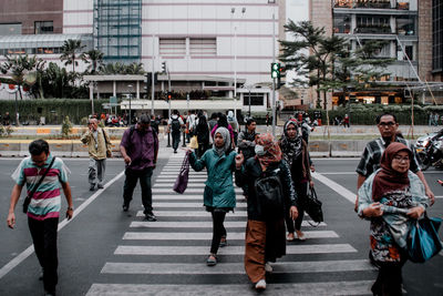 People walking on road in city