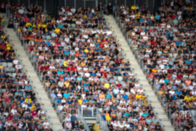 Defocused image of people cheering at stadium