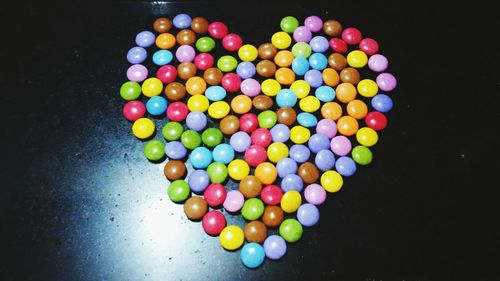 Close-up of multi colored candies against black background