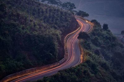 High angle view of illuminated road amidst trees