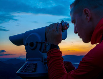 Portrait of young man against sky during sunset