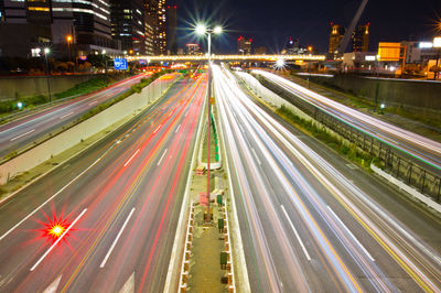 High angle view of light trails on highway at night