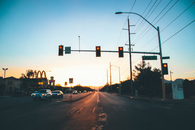 Cars on road at sunset