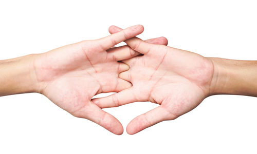 Close-up of hands over white background