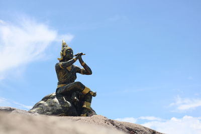 Low angle view of statue against blue sky