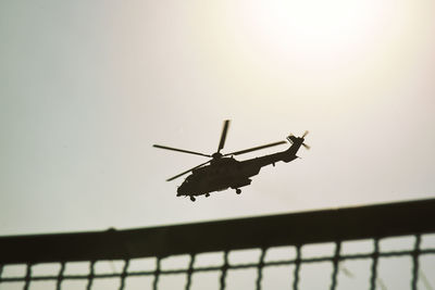 Low angle view of silhouette airplane against clear sky