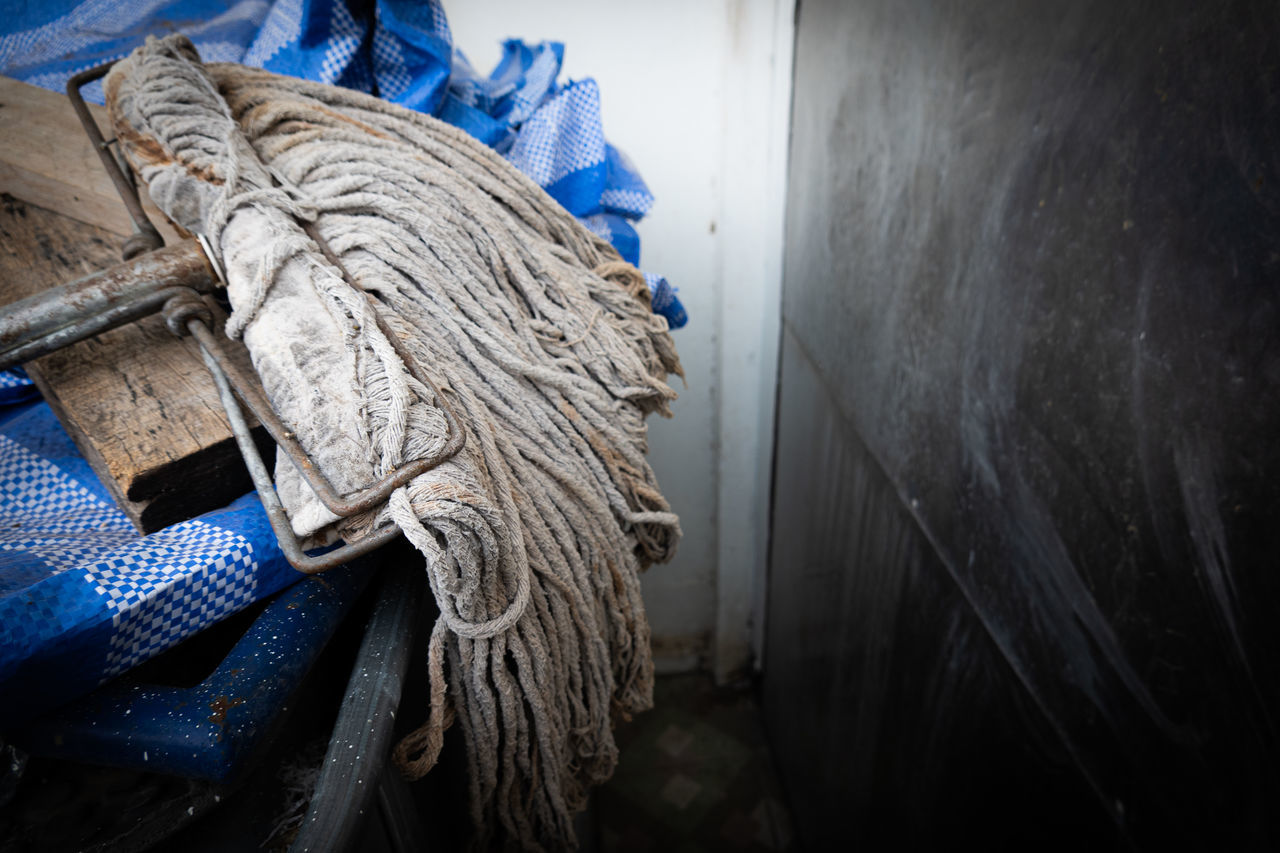 CLOSE-UP OF ROPE AGAINST WALL