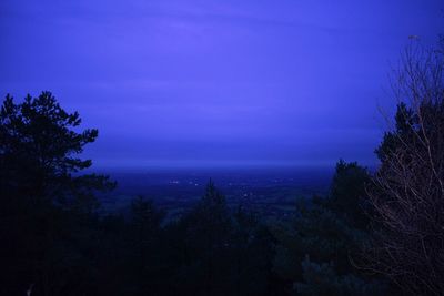 Scenic view of silhouette trees against sky at night