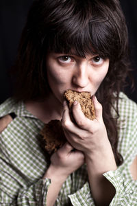Portrait of poor woman eating bread