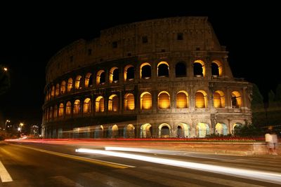 Light trails on historical building at night