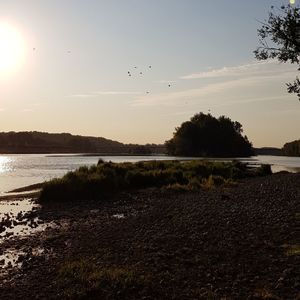 Scenic view of lake against sky during sunset