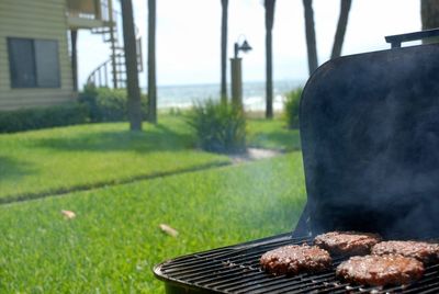 Close-up of meat on barbecue grill in yard