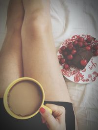 Midsection of woman holding coffee cup