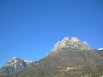 Low angle view of mountain against clear blue sky