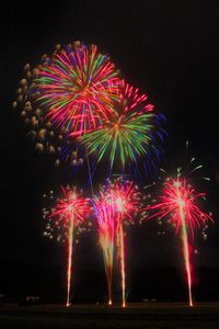 Low angle view of firework display at night