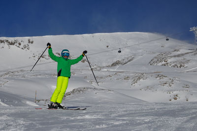Man skiing on snow covered field