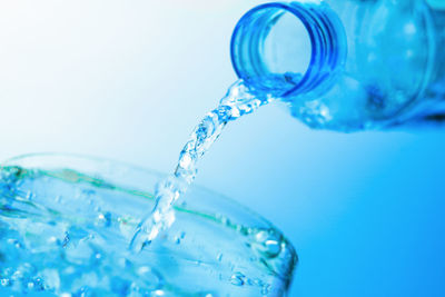 Close-up of water splashing against blue background