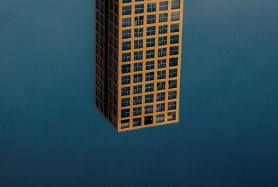 Low angle view of building against blue background