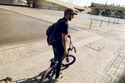 Man performing stunt on bicycle in city 