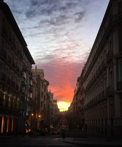 Buildings in city against cloudy sky