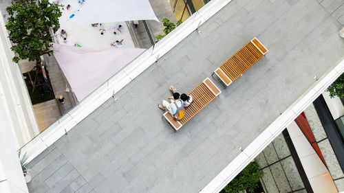 High angle view of people walking on railing against buildings