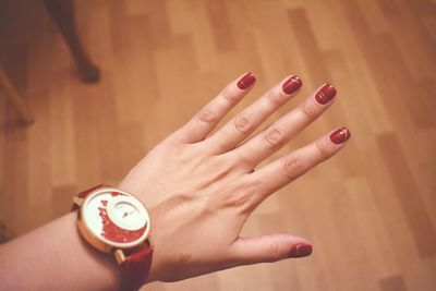 Cropped hand of woman with pills on table