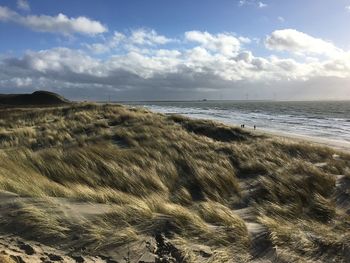 Scenic view of sea against cloudy sky