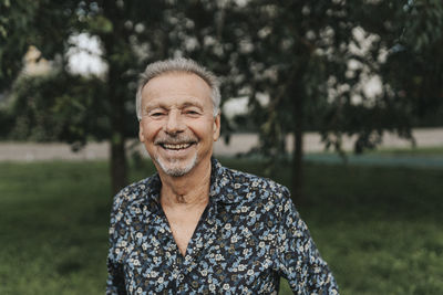 Portrait of happy senior man at park