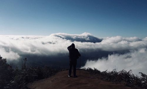 Rear view of man standing against sky
