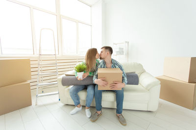 Woman sitting on table at home