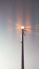 Low angle view of street light against sky at sunset