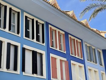 Low angle view of colorful condominium building against sky in sotogrande, southern spain. 