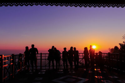 Silhouette people against sky during sunset