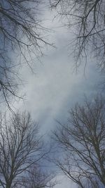 Low angle view of bare tree against cloudy sky