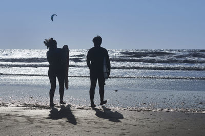 People on beach against sky