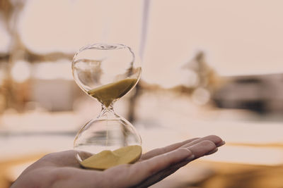 Close-up of person holding glass against blurred background