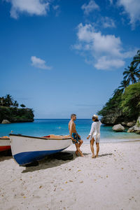 People on beach against sky