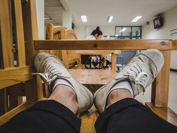 Low section of man sitting on wooden floor