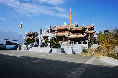 Temple buildings against sky in city