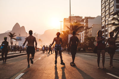 Rear view of people walking on road