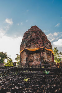 Low angle view of old temple building against sky