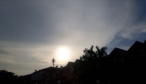 Low angle view of silhouette trees against sky at sunset