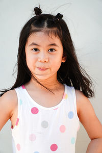 Portrait of young woman against white background