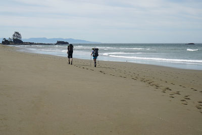 People on beach against sky