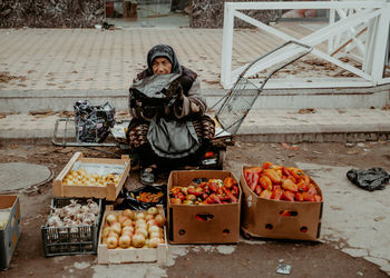 Woman selling fruits and vegetables at market stall