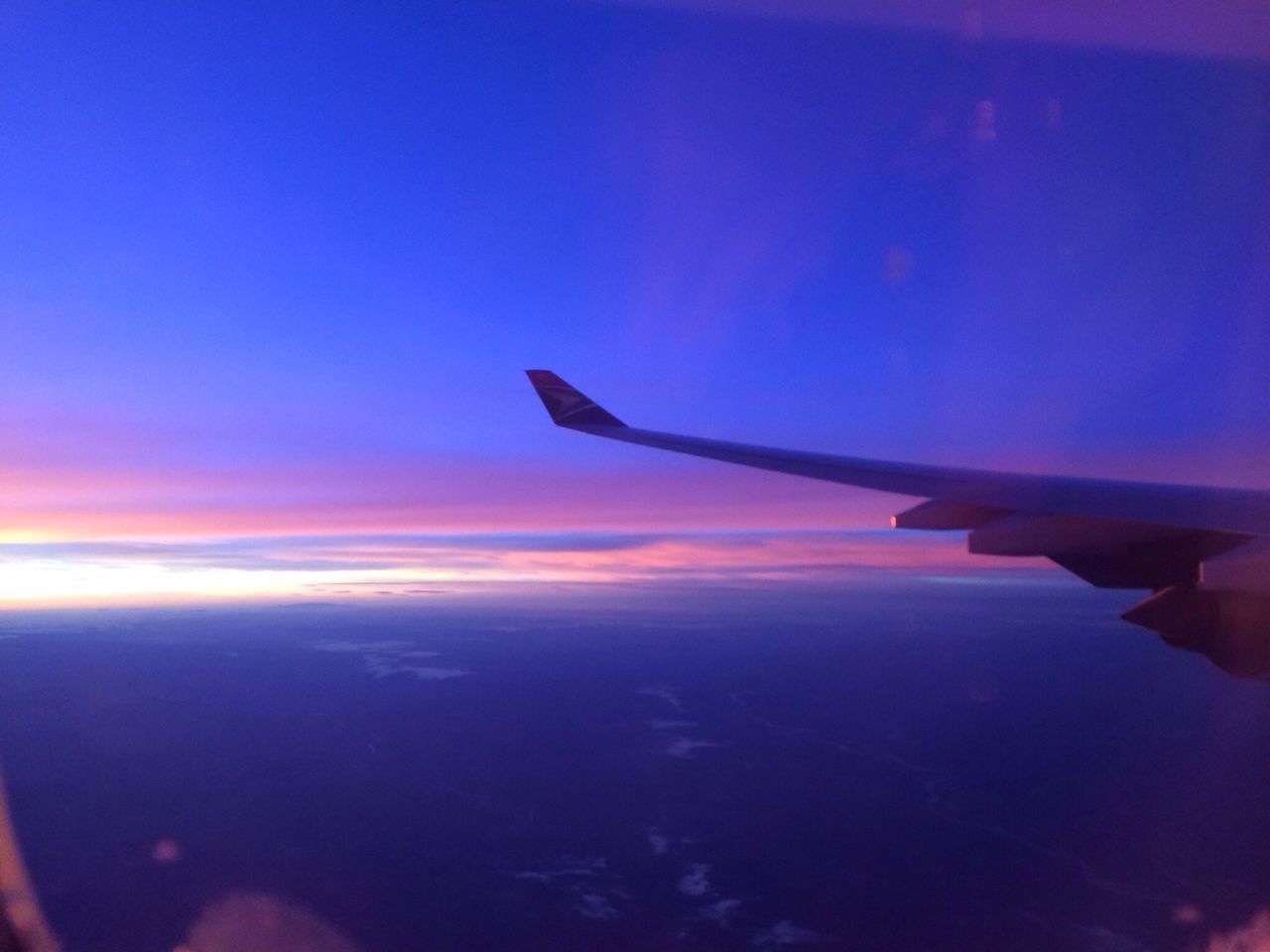 airplane, transportation, mode of transport, air vehicle, aircraft wing, flying, aerial view, part of, travel, sunset, scenics, cropped, sky, beauty in nature, blue, journey, mid-air, sea, nature, on the move