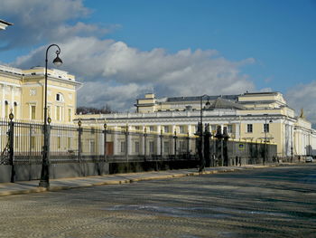 Buildings in city against cloudy sky