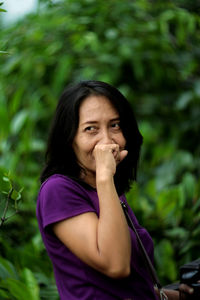 Portrait of woman against purple outdoors