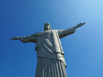 Low angle view of statue against clear blue sky