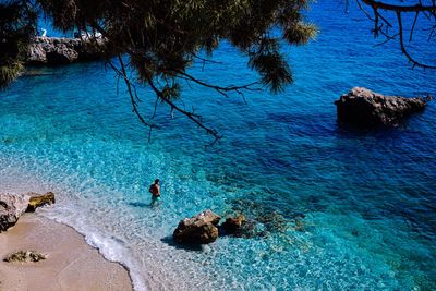 High angle view of rocks on sea shore